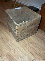 Angled view of wooden crate exterior with logo