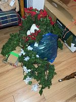 Group of wreaths, garlands and boxed NOMA tabletop tree on floor