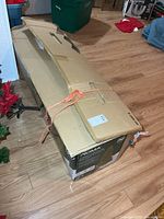 Sealed cardboard box containing Noma tree