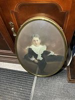 Full view of oval frame leaning against furniture