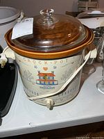 Front view showing design, lid, control knob