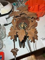 Full view of cuckoo clock, weights, pendulum