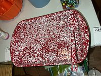 Top view of speckled enamel pan with spoon inside