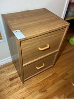Front angled view of wood 2-drawer file cabinet