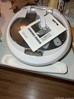 Top view of round George Foreman grill with manual on lid