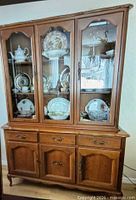 buffet with hutch assembled, showing glass doors, shelves and mirrored back