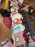 All eight crocheted-top kitchen towels laid out on bench
