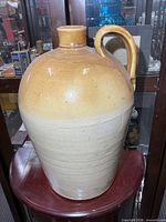 Front view of two-tone stoneware jug on stand