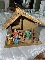 Front view of wooden stable and all figures