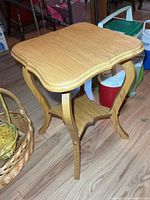 three-quarter view showing curved legs and lower shelf