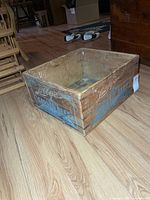 Full view of wooden crate interior and side branding