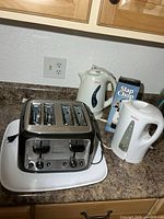 Group shot showing 4-slice toaster, two kettles and Slap Chop box
