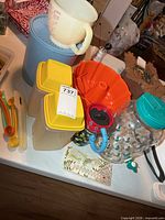 Group shot of all items including cruets, canister, measuring pitcher, utensils, bundt pan, mug and glass dispenser