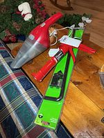 All three items: cordless vacuum, packaged caulking gun, packaged 18" cane bolt