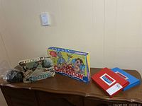 Overall view showing Probe, Operation, Battleship cases, dominoes bag on surface