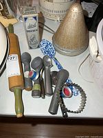 Group shot of all utensils including rolling pin, scoops, bottle box, spoon, strainer, cutter