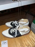 Top view of both saddle shoes showing two-tone coloring and laces