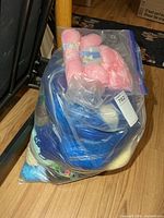 Full view of clear bag containing mixed yarn skeins