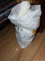Full bag of yarn standing on floor