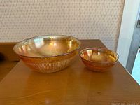 Large and small Imperial marigold carnival glass bowls side by side