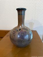 full view of vase front showing shape and decoration