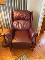Front view of burgundy leather wingback recliner showing upholstery and shape