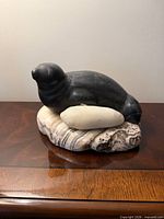 Full view of soapstone seal on stone base
