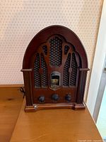 Front view of GE cathedral radio showing grille, dial, knobs