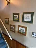 All five framed farmhouse prints displayed on stairway wall