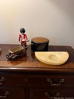 All four decorative items grouped on furniture top