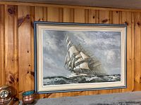 Front view of framed signed sailboat oil painting
