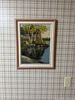 Full view of framed landscape painting on wall