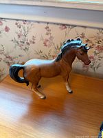 Left side view of brown porcelain horse figurine