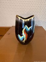 Front view showing full height, glaze color, and abstract motif