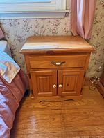 Front view of solid wood nightstand with drawer and cabinet doors