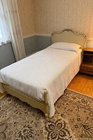 Full view of assembled twin bed showing headboard, footboard and mattress