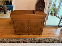 Front view of wood dry sink showing drawer, doors, hardware, and top basin