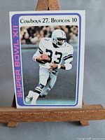 Front view of 1978 Topps Super Bowl XII card on small wooden easel