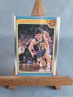 Front view of 1988 Fleer John Stockton card in sleeve and top loader on easel