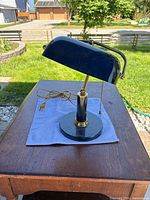 Full view of banker’s lamp on table showing shade, column and base