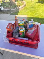Overall view of lot showing red trays holding assorted cleaning products