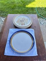 Stack showing floral plate pattern and blue-rim plate