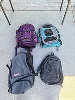 Group shot of four backpacks placed on ground