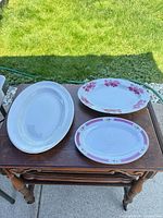All three oval platters on table showing size and patterns