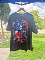 Front view of black Captain America graphic T-shirt on hanger