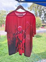 Full front view of red/black Deadpool T-shirt on hanger