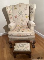 Front view showing chair, embroidery, footstool and legs