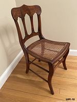 Three-quarter front view of the wooden chair showing overall design and condition
