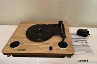 Top view of Ion Archive LP turntable showing platter, tonearm, speakers, and controls
