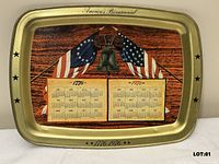 Front of gold-tone tray showing Bicentennial graphics and calendars